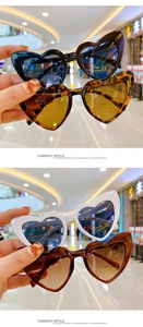 Detailed view of heart-shaped sunglasses featuring UV 400 protection and CE certification