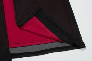 Detailed view of the double-layered hem with black mesh and red fabric stitching