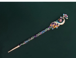 Detailed close-up of peacock hair stick featuring colorful enamel and sparkling rhinestones