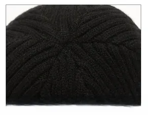 Detailed macro view of the seamless stitching and knit texture on the black beanie crown