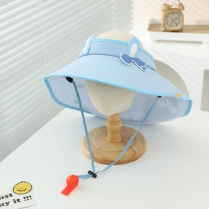 Macro detail of a blue sun visor hat featuring rabbit ears and a bow on a wooden stand