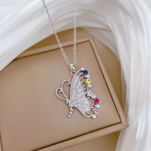 Macro shot of sparkling silver butterfly necklace with multi-colored gemstones and crystals