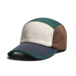 Retro multi-color patchwork camper cap with side ventilation holes in a 45-degree side view