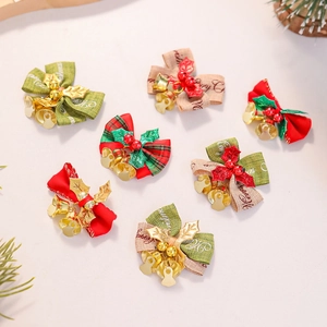 Detailed view of assorted Christmas linen bows with golden bells and berries decor