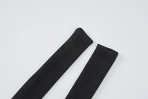 Close-up of black knitted fabric texture and seamless shoulder strap on the dress