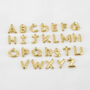 Macro view of 26 3D golden 18K titanium steel letter pendants for necklace DIY jewelry