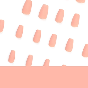 Matte nude pink short ballerina press-on nails set displayed in an organized row