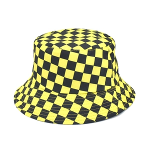 Detailed view of yellow and black checkerboard pattern on a sturdy canvas bucket hat