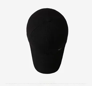 Top view of a black winter baseball cap featuring a six-panel structure and metal side logo