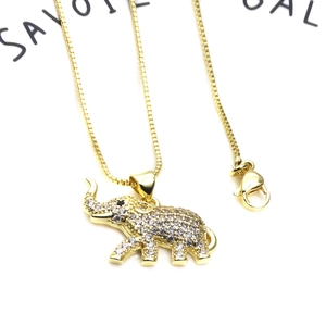 Macro detail of elephant pendant with pave white cubic zirconia and gold plating
