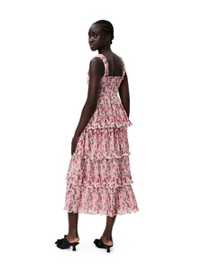 Detail of pink floral tiered cake dress featuring ruffled textures and a sleeveless design
