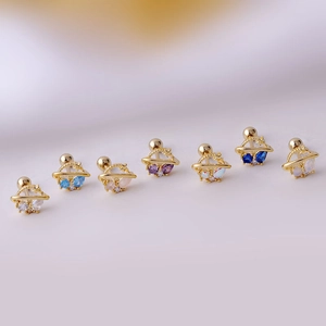 Golden planet stud earrings with colorful zircon stones in a curved row display
