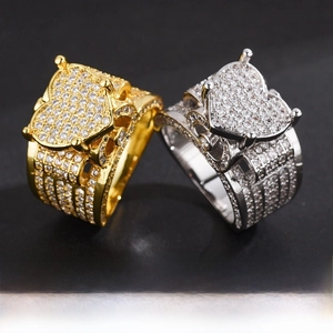 Macro detail of gold and silver hip-hop rings with micro-paved cubic zirconia