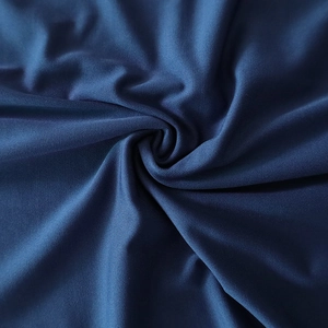 Detail of navy blue high-elastic fabric featuring elegant spiral pleats and fine texture