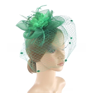 Detail view of emerald green vintage fascinator with mesh veil and feather floral accents