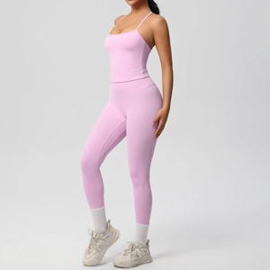 Pink seamless yoga set with thin strap tank top and high waisted leggings on model