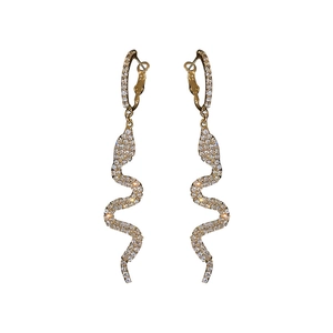 Elegant gold snake drop earrings with sparkling white crystals on white background