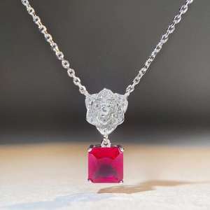 Detail of S925 silver necklace with white diamond petals and square red ruby pendant