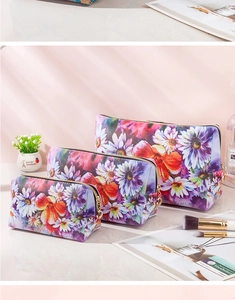 Three-piece floral waterproof makeup bag set in different sizes with gold zipper