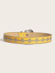 Detail of yellow crocodile embossed leather belt with silver studs and metal buckle