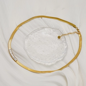 Elegant gold snake chain necklace with square cubic zirconia on white silk and glass
