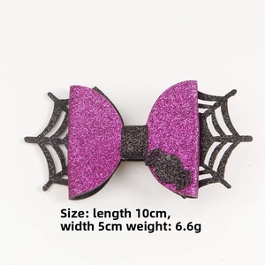 Detail of Halloween bow clip with spider web design measuring 10cm x 5cm in purple and black