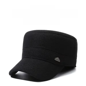 Detail of winter men's flat top cap with thick herringbone fabric and metal mountain logo