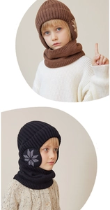 Detail of warm knitted hat and scarf set for children with snowflake pattern and ear flaps