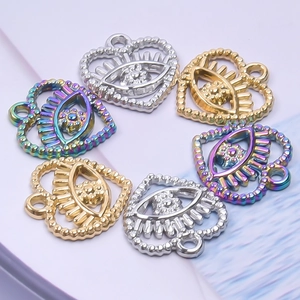 Macro detail of colorful heart eye charms in gold, silver, and rainbow steel plating