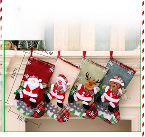 Detailed view of four large burlap Christmas stockings with festive character patches