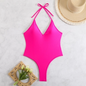 Detailed flat lay of hot pink halter swimsuit with deep V-neck and back tie straps