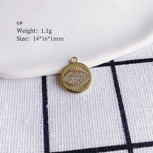 Detailed view of evil eye gold pendant showing 14x16x1mm dimensions and 1.1g weight