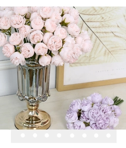 Detailed view of pink and lavender silk peonies in a sleek glass and metal vase