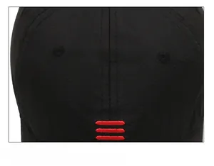 Close-up of durable top stitching and red embroidery on black quick-dry baseball cap