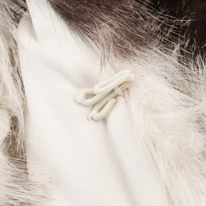 Macro detail of high-quality animal print faux fur coat with white hook closure and lining
