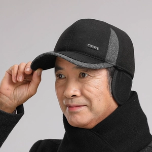 Detail of winter baseball cap for men with ear flaps and SPORT metal emblem