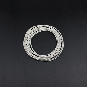 Macro detail of silver guitar string spring bracelet with multi-layer coil design
