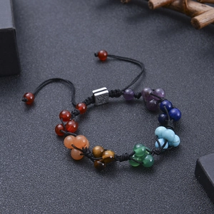 Detail of seven chakra bead bracelet with tree of life charm and adjustable black cord