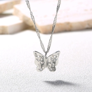 Close-up of a silver butterfly pendant necklace with sparkling rhinestone details