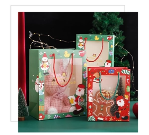 Detail of Christmas gift bags with transparent windows and festive cartoon characters