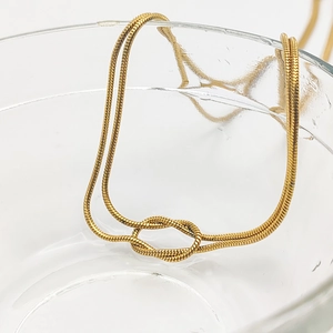 Elegant gold-plated stainless steel snake chain necklace with a minimalist knot pendant design