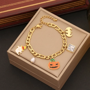 Close-up of gold Halloween bracelet with ghost and pumpkin charms in a jewelry box