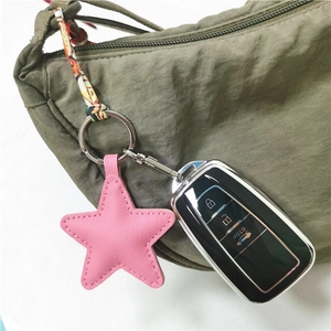 Pink leather star charm on army green bag with car key remote and silver metal clasp