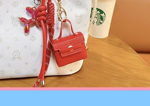 Leather mini bag keychain and bag charm, stylish red coin purse pendant for keys and bags.