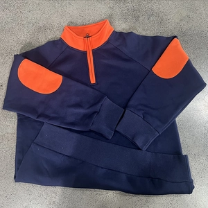 Detail of navy quarter-zip sweatshirt with vibrant orange elbow patches and metal zipper