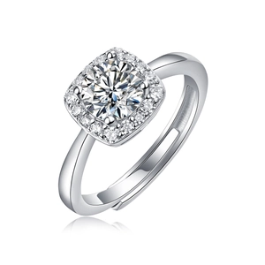 Macro detail of silver ring featuring a round moissanite with square halo and open band