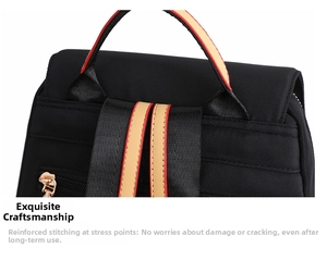 Close-up of black fabric backpack top handle with red and brown contrast trim