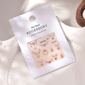 Close-up of heart-shaped nail jewelry set MJ-041 on a decorative ceramic plate