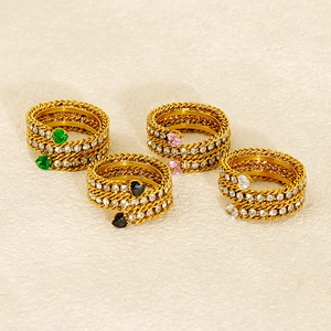 Detailed view of four 18K gold-plated heart zircon rings in green, black, pink, and white