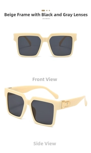 Macro shot of stylish square sunglasses featuring beige frames and gold M-shaped metal hinges